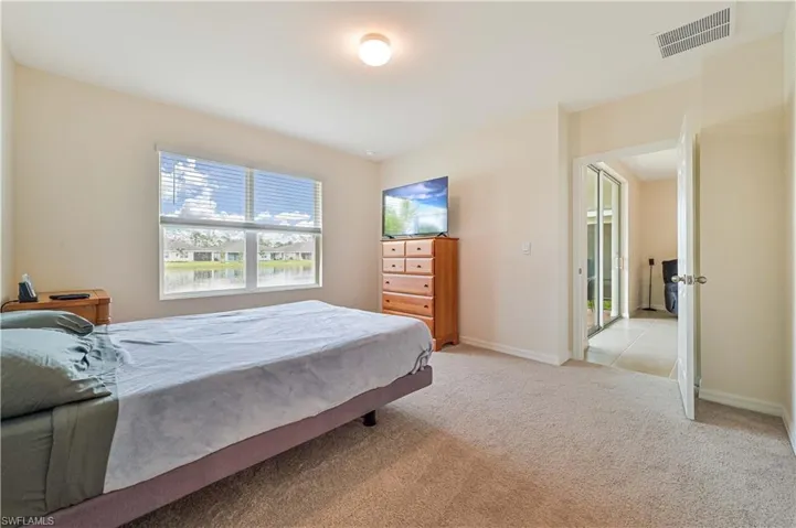 Bedroom featuring light carpet