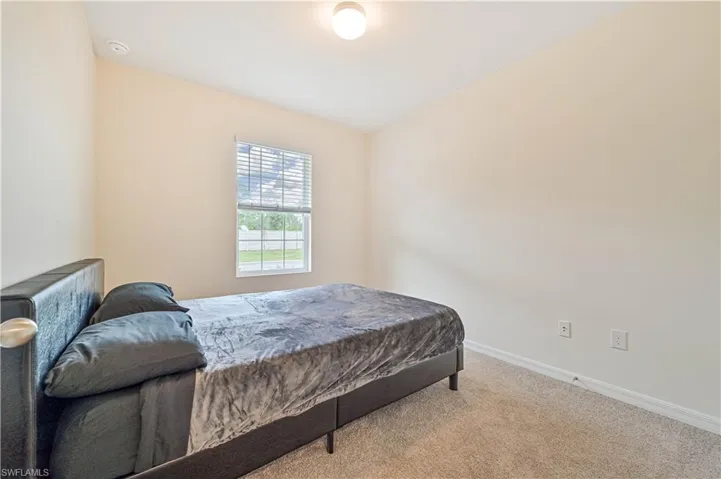 Bedroom with light carpet
