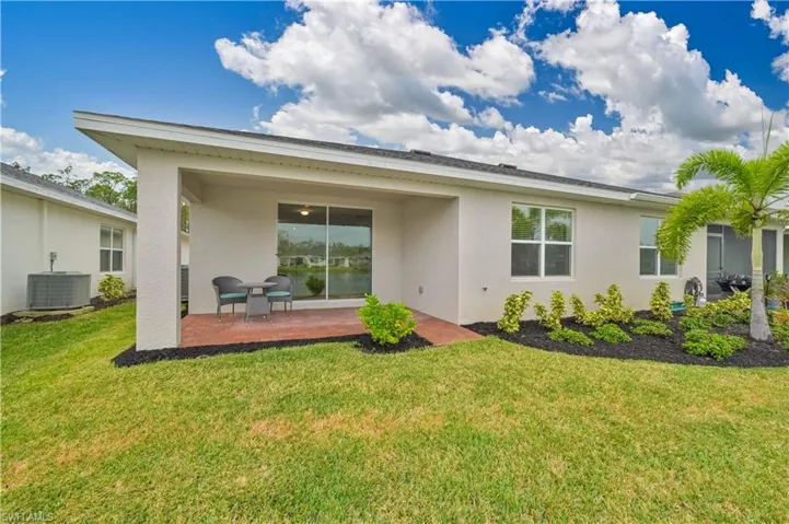 Rear view of property with a lanai