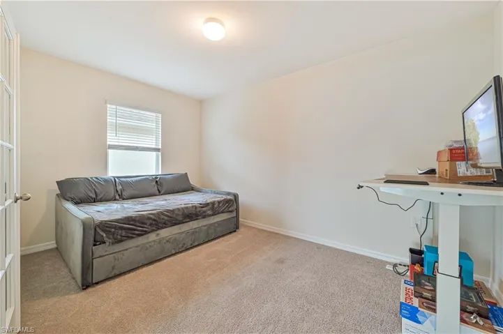 Living area with light colored carpet