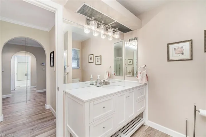 Full bathroom featuring vanity and light wood-type flooring