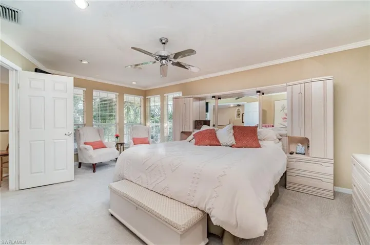 Bedroom featuring light colored carpet, ornamental molding, a ceiling fan, and recessed lighting