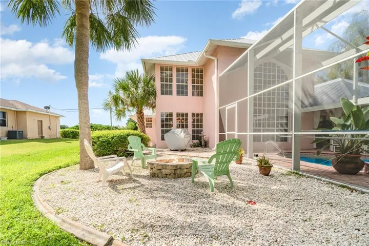 Back of property with a lanai, a sunroom, a patio, and a metal roof