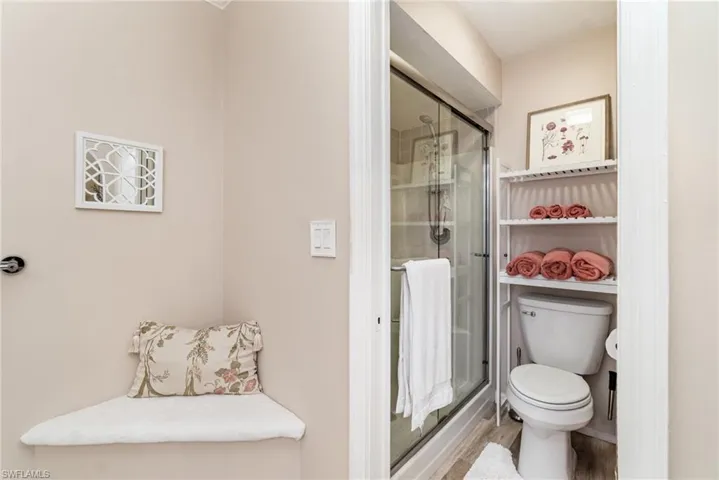 Bathroom featuring a stall shower and wood finished floors