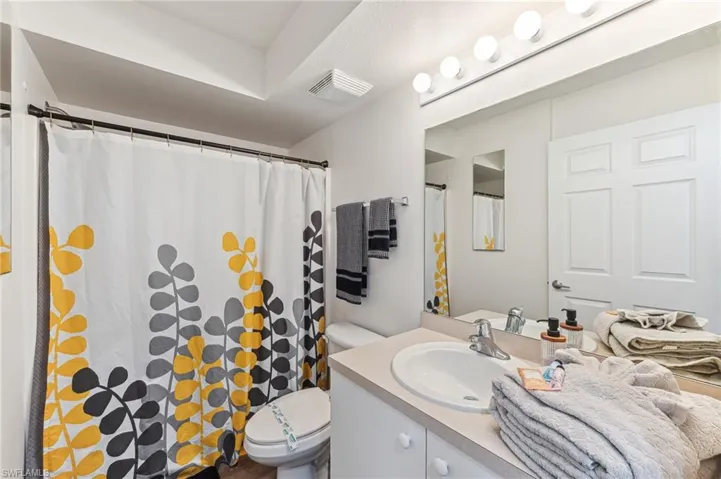 Bathroom featuring vanity and a shower with shower curtain