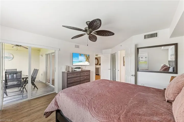 Bedroom with light wood finished floors, a ceiling fan, access to exterior, and a closet