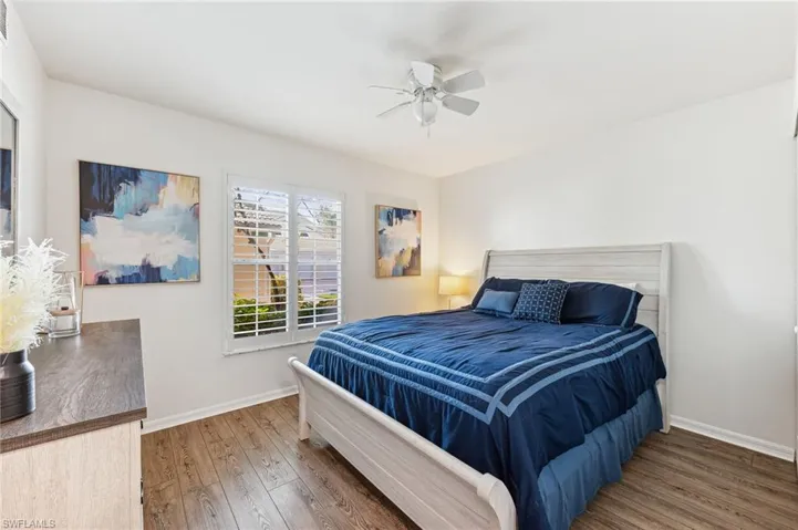 Bedroom featuring hardwood / wood-style floors and a ceiling fan