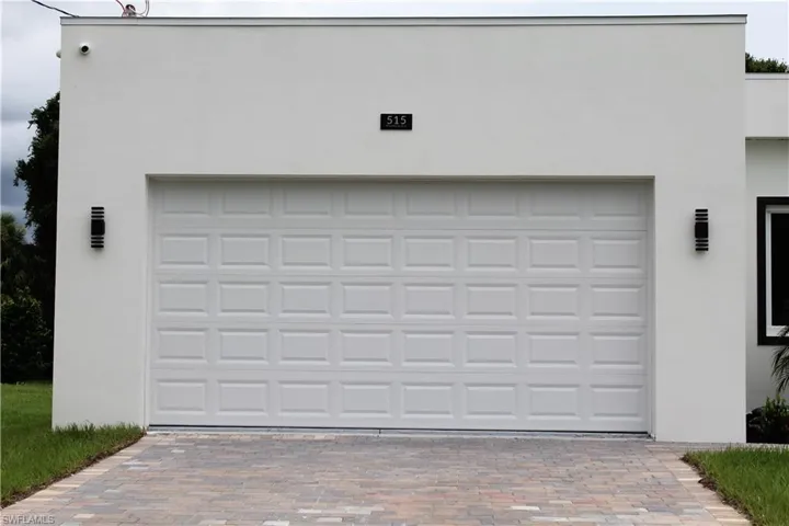 Garage featuring decorative driveway