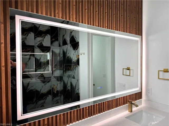 Bathroom view of a marble finish shower and vanity