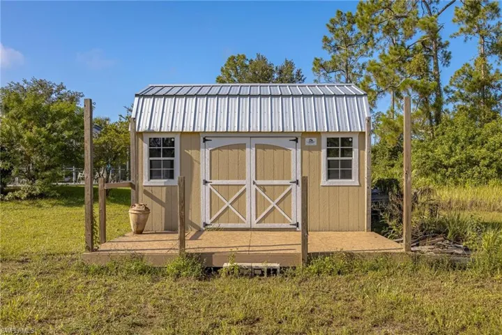 View of outdoor structure with a lawn