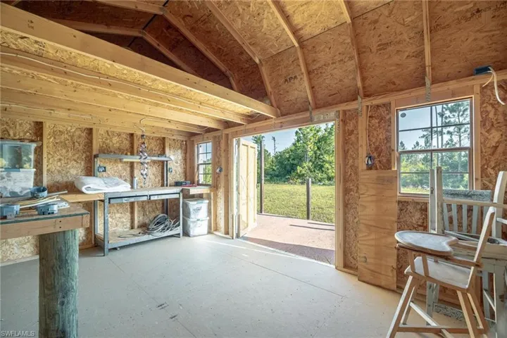 Unfurnished sunroom featuring vaulted ceiling