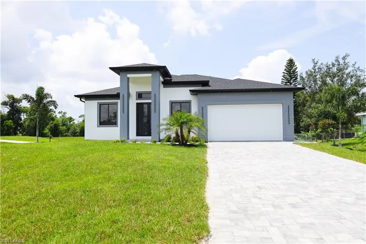 Prairie-style home with a garage and a front lawn