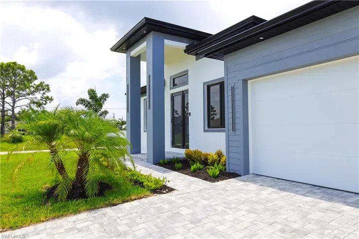 Doorway to property with a garage