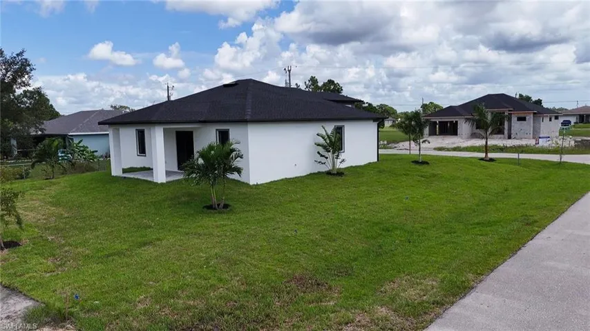 View of side of home featuring a yard