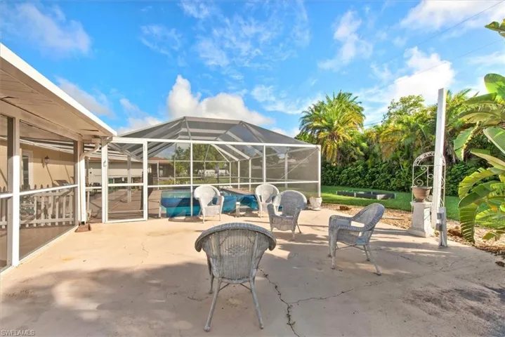 View of patio / terrace with glass enclosure, a sunroom, and a swimming pool