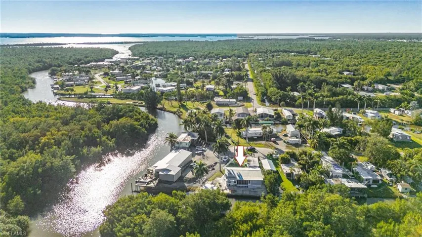Drone / aerial view with a water view, a residential view, and a view of trees