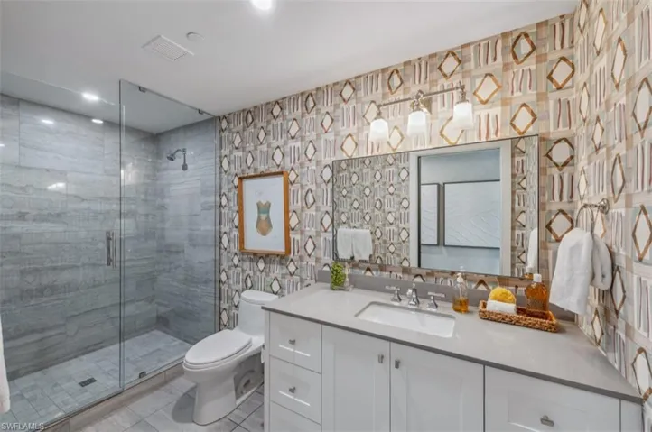 Bathroom featuring vanity and a stall shower