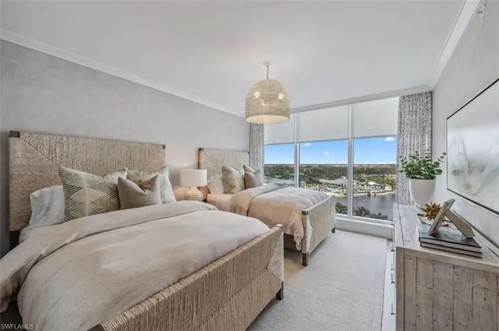 Carpeted bedroom with ornamental molding