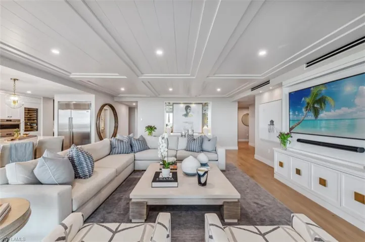 Living area with light wood-type flooring and recessed lighting