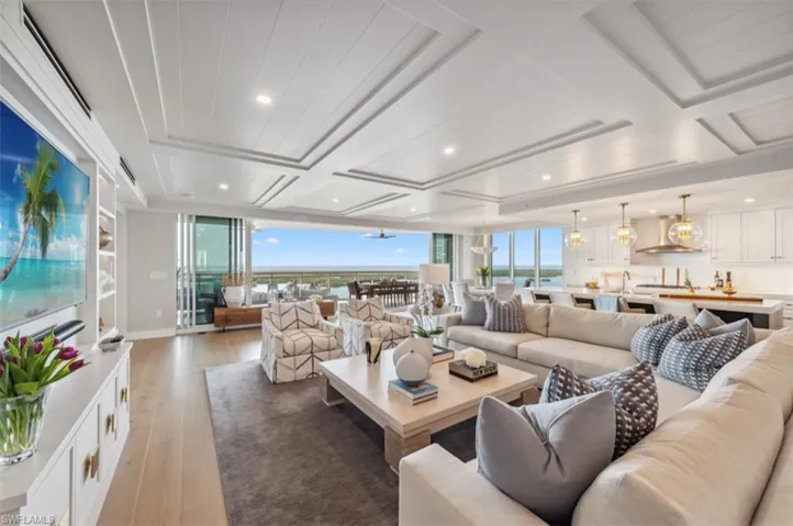 Living room featuring light wood-style floors, a ceiling fan, floor to ceiling windows, and recessed lighting