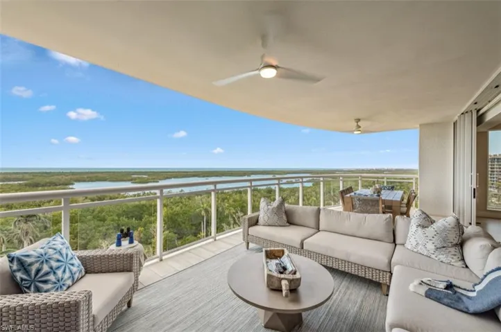 Balcony with ceiling fan, outdoor lounge area, and a water view
