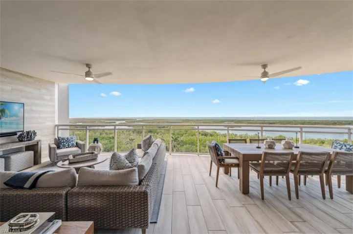 Wooden terrace featuring an outdoor living space, outdoor dining area, a ceiling fan, and a patio