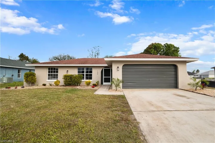 Single story home with a front yard, a garage, and central air condition unit