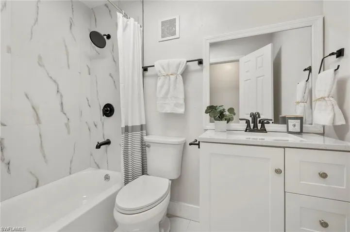 Full bathroom featuring vanity and shower / tub combo