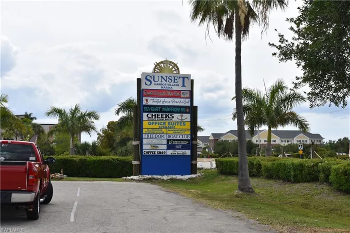 Prominent multi-tenant signage at Sunset Harbor Village Marina