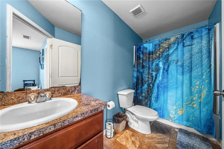 Bathroom with vanity and shower / bath combo