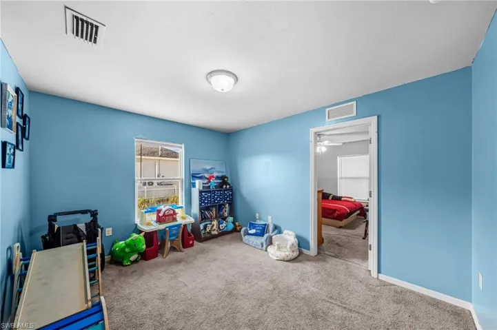 Game room featuring carpet flooring and a ceiling fan
