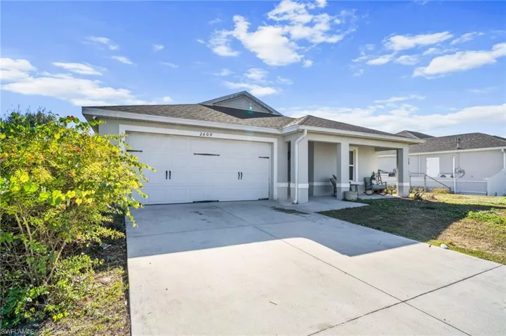 Ranch-style house with concrete driveway, stucco siding, and a garage