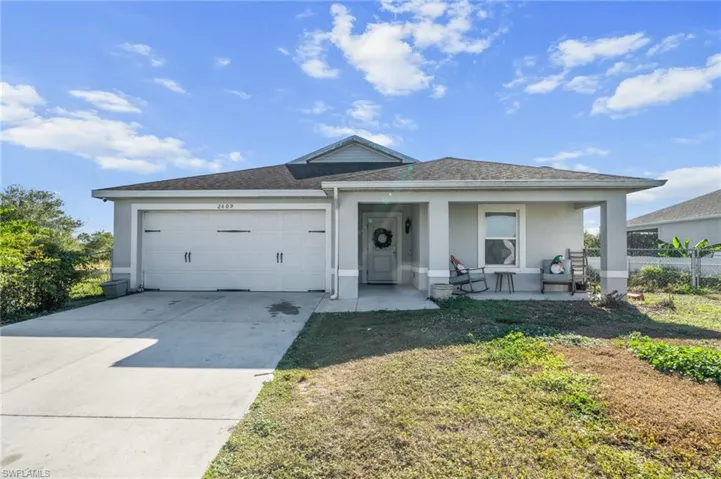 View of front of home featuring stucco siding, concrete driveway, a garage, a shingled roof, and covered porch