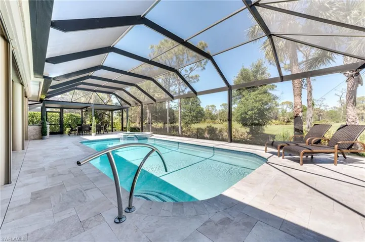 Beautiful tiled pool deck and contemporary stainless railing
