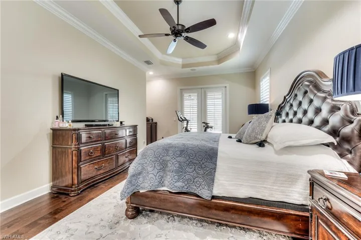 Primary bedroom with French doors to the outdoor TV area