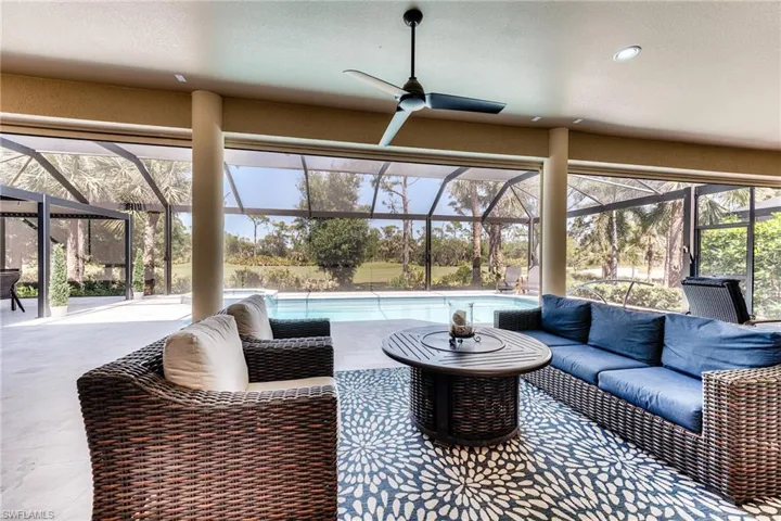 Cocktail area on covered lanai with a fire pit.  These large openings all have electric roll-down shutters