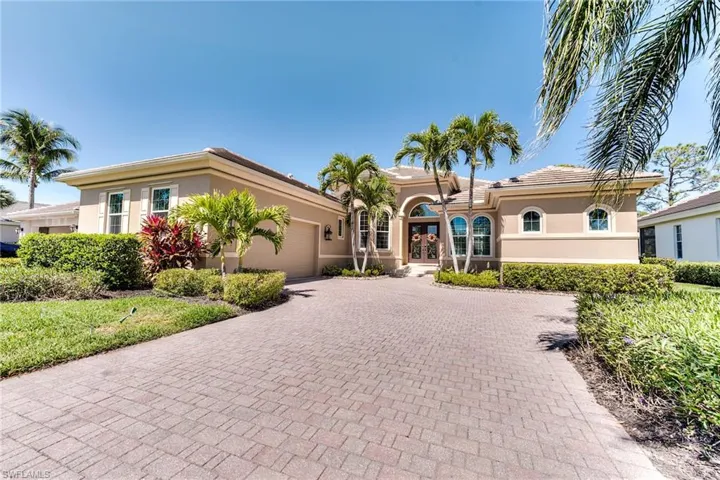 Large paver stone driveway and side load garage