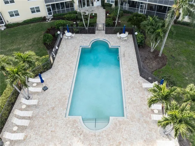 View of swimming pool featuring a lawn and a patio