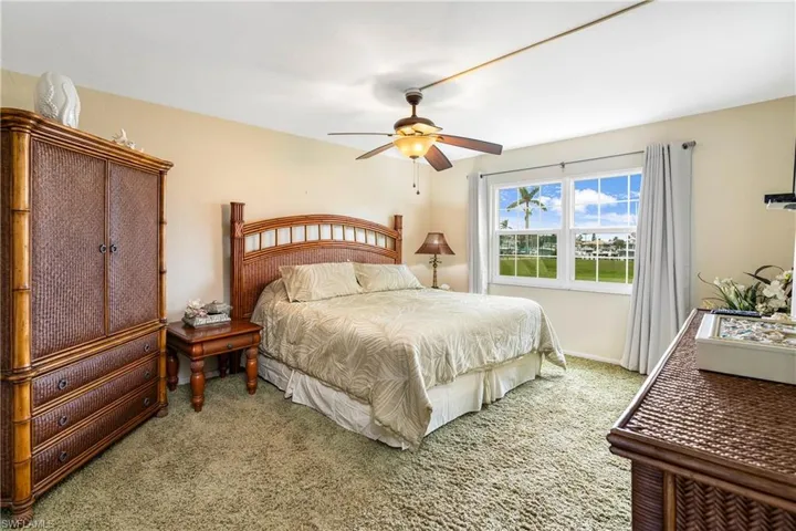 Bedroom with ceiling fan and carpet flooring