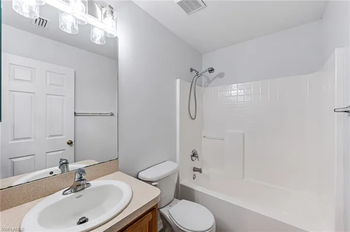 Full bathroom with toilet, shower / bathing tub combination, and vanity