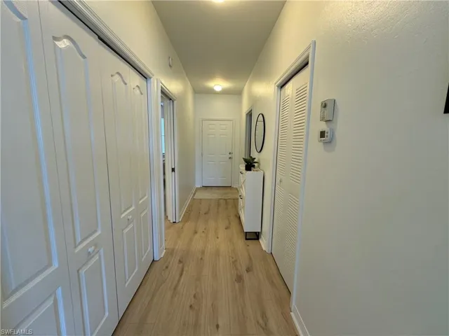 Hall featuring light hardwood / wood-style flooring