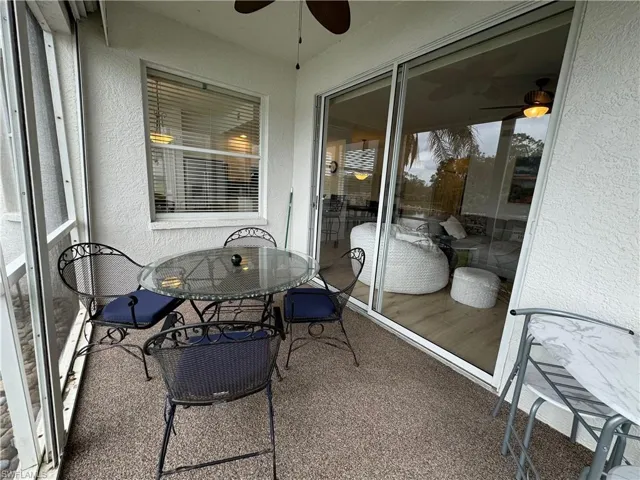 Sunroom / solarium featuring ceiling fan