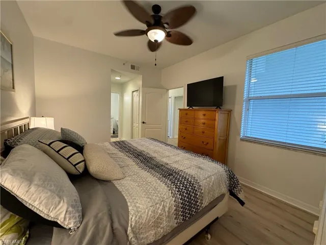 Bedroom featuring light wood-type flooring, ceiling fan, and a closet