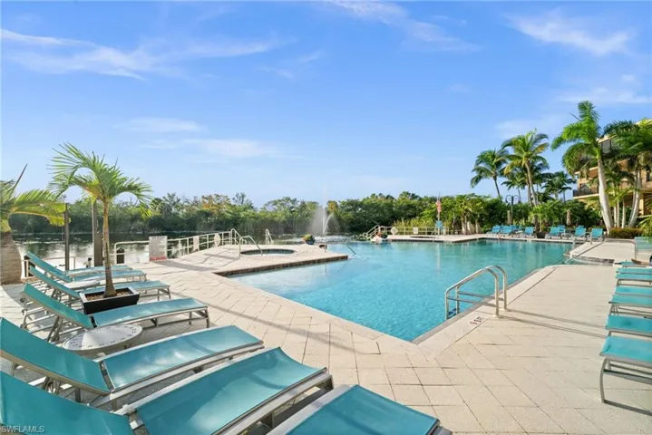 Community pool with a patio and a hot tub