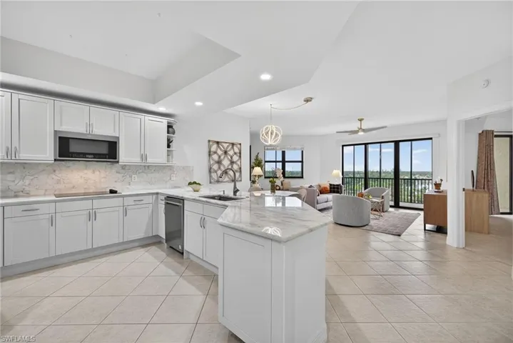 Kitchen featuring open shelves, a peninsula, decorative light fixtures, recessed lighting, and white cabinetry