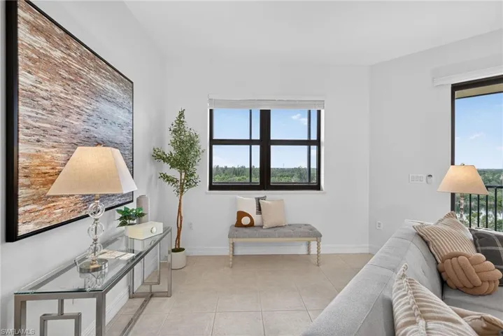 Living room featuring light tile patterned floors and baseboards