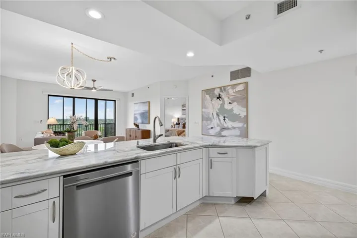 Kitchen featuring white cabinetry, dishwasher, recessed lighting, light tile patterned floors, and light stone countertops