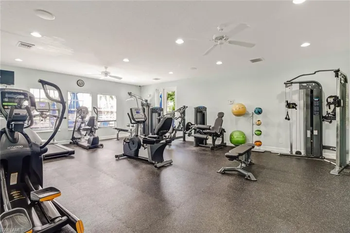 Workout area featuring a ceiling fan and recessed lighting