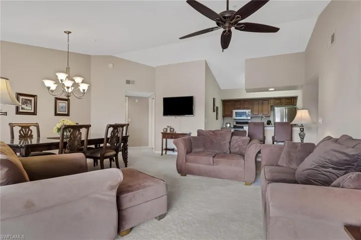 Living room with vaulted ceiling and ceiling fan