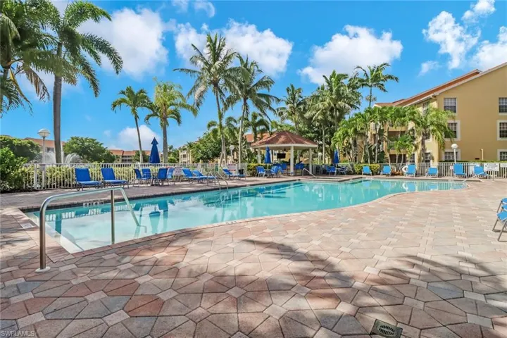 Community pool with a patio area and a gazebo